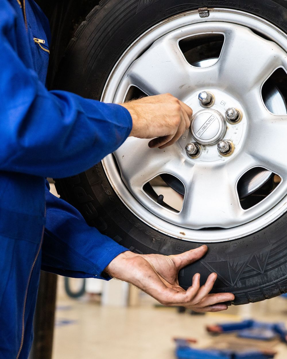 Technician lifting a wheel into place